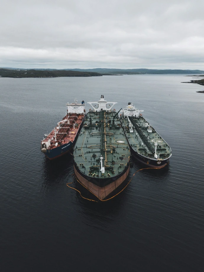 black and brown ships under cloudy sky